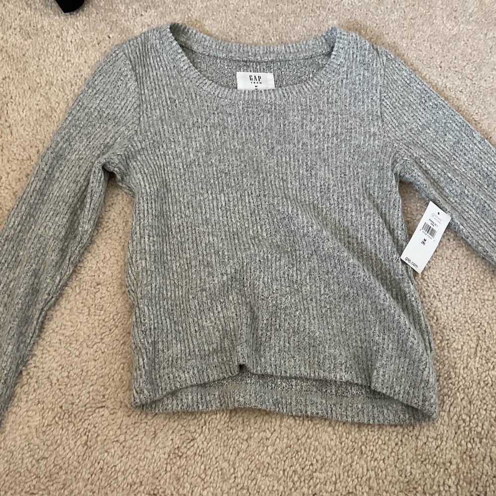 I am selling a kids grey sweater!